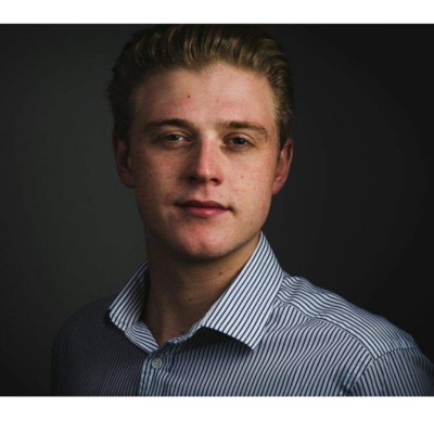 Jack is a young white man wearing a blue and white striped shirt